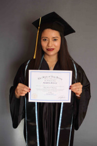 woman dark hair holding a high school diploma